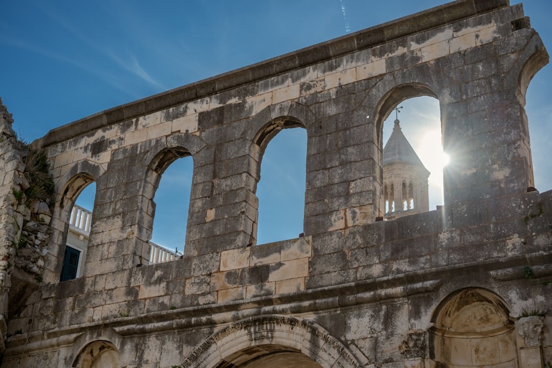 Weathered wooden shutters on a stone building in Split old town at midday