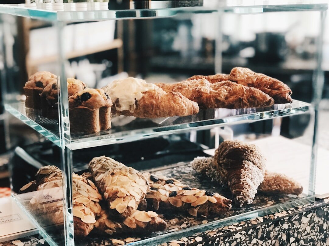 Fresh pastries displayed in a glass case at a newly opened marina cafe