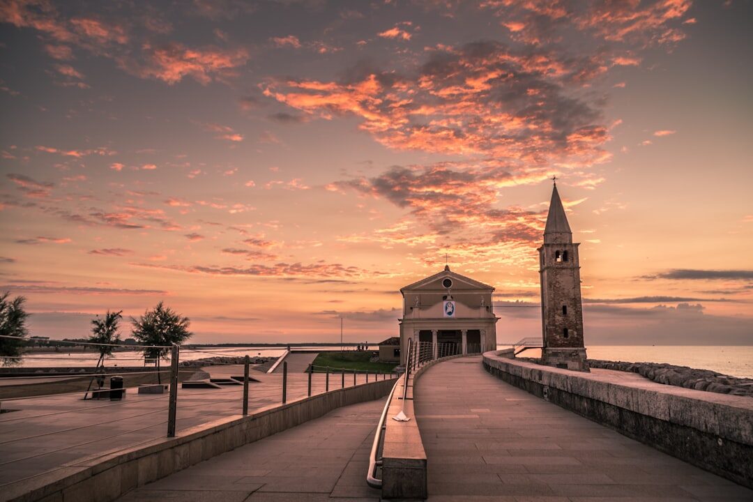 Calm sea and stone pier near Zadar at sunrise with soft pastel sky