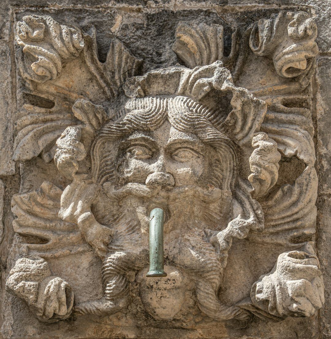 Weathered stone doorway with an old iron knocker in Dubrovnik old town