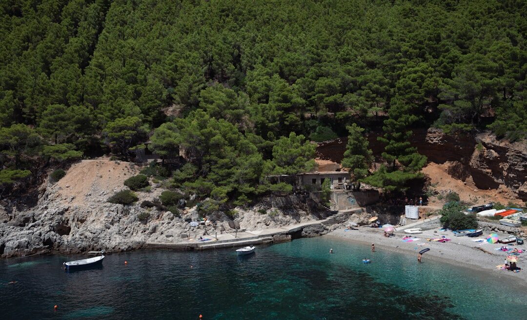 Single wooden boat anchored in a secluded turquoise cove along the Croatian coast
